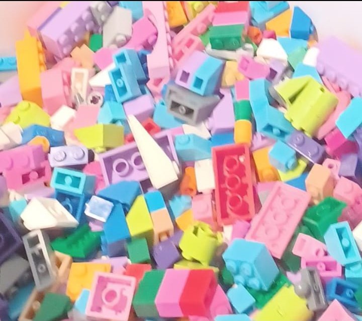 A colourful assortment of various small plastic building blocks.